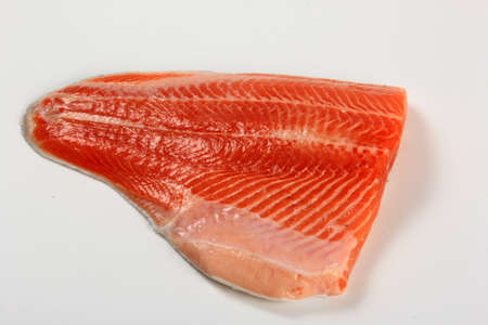 Raw trout fillet isolated on white background. Raw orange salmon fish filletの写真素材