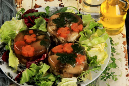 Meat aspic, jellied slow cooked meat on a plate.National Russian dish Holodec, jelly with parsley and carrotsの写真素材