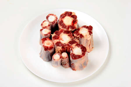 Raw uncooked ox or cow tail on white isolated backgroundの写真素材