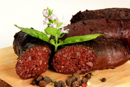 Baked blood sausage. Buckwheat sausage. Bloody sausages on wooden cutting board. homemade black...