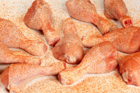 Raw chicken legs with spices on a white background. selective focus.の写真素材