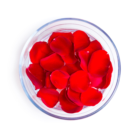 beautiful pink rose petals in glass bowl isolated on whiteの写真素材