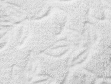 White furry fabric with floral ornament. Close upの写真素材