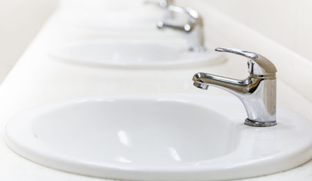 faucet and sink in a public toiletの写真素材