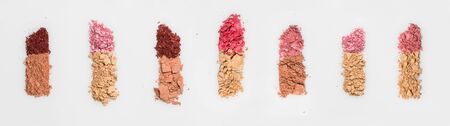 Set of seven lipsticks made from crashed face powder and blush, isolated on white background.の写真素材