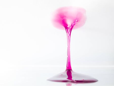 The viscous substance in the form of a colored gel is stretched between two planesの写真素材