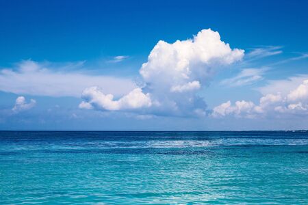 the Caribbean. A saturated blue sky, clouds and the sea.の写真素材