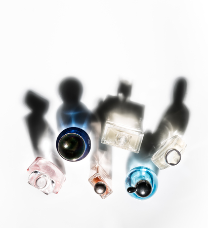 Shadows of perfume bottles in the form of communicating various human characters.の写真素材