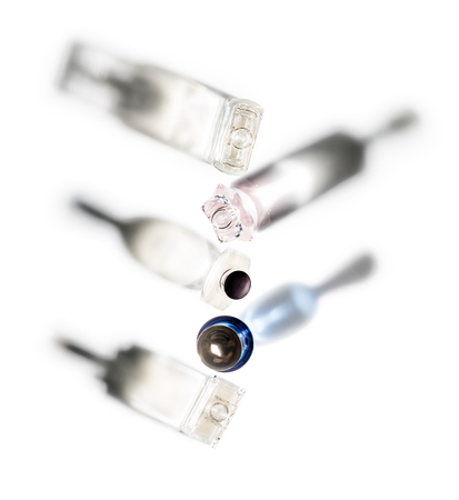 Shadows of perfume bottles directed in different directions on a white background.の写真素材