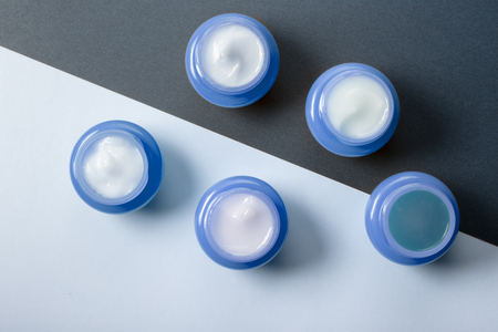 A set of five blue jars with moisturizers for day and night use. Mens cosmetics for skin care.の写真素材
