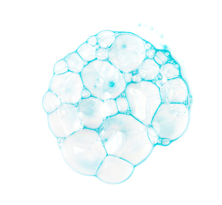 Soap bubbles on a white background from blue shower gel, top view.の写真素材