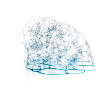 Soap bubbles with a blue tint in the form of caps isolated on white background.