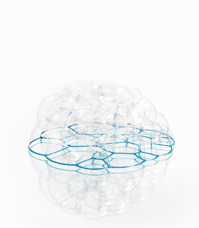 Soap bubbles with reflection on white background.