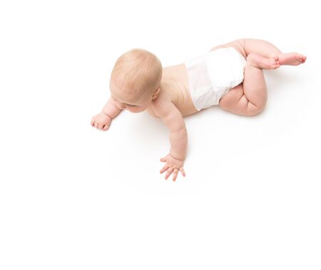 Crawling happy baby isolated on white ookinf at floorの写真素材