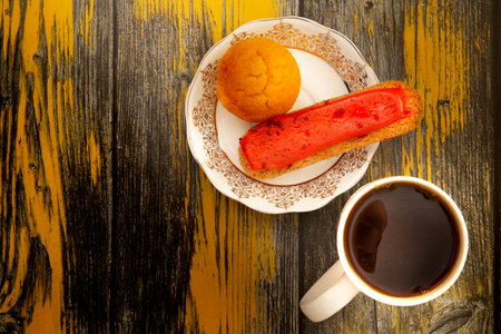 Coffee cup with pies top view on wooden with old yellow paintの写真素材