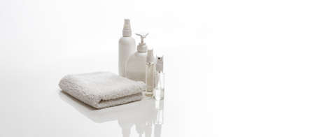 white spa towel and jars with bottles of body careの写真素材