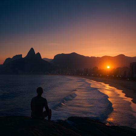 Man silhouette sitting on beach watching sunrise. Ocean scenery. Serenity landscape peaceful coastline waves relaxation travel tourism destination.の素材