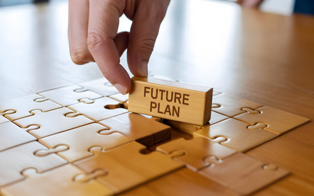 Creative solution hand placing wooden block with future plan. Business strategy development using puzzle pieces and plan.の素材