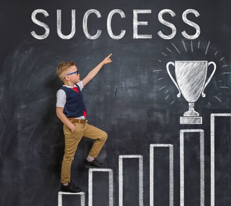 Portrait of little businessman kid boy. Success, creative and start up concept. Success and win conceptの写真素材