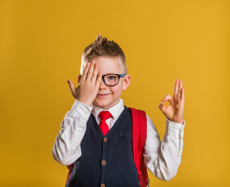 education, school and vision concept - smiling cute little kid boy in black eyeglasses