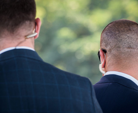 Protection and guard service. Bodyguard man with earphone and black eyeglasses and business suit...