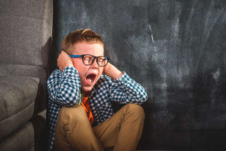 Alone kid shout. Child abuse. School kid boy bully and sad. violenc in family form parent. Anxiety and stress. Back to school.の写真素材
