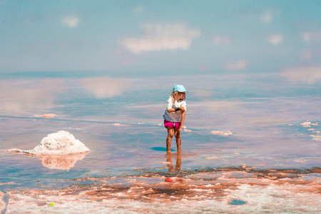 Little kid girl at The Dead Sea, Israel. Salt lake water. healthcareの写真素材