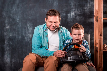 father and son play video game at home. Funny time.