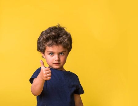 happy child and gestures concept. picture of smart boy showing thumbs up. Sign of like. Kindergarten...