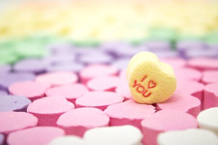Multi-colored candy message hearts with "I Love You" on yellow heartの写真素材