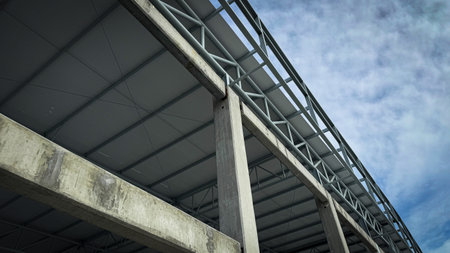 Concrete column and steel roof truss structure under construction, architectural framework detail...
