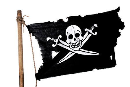 Waving in the wind pirate flag on the mast. Isolated on whiteの写真素材