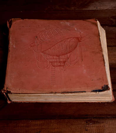 Old shabby closed book with embossed balloon on the coverの写真素材