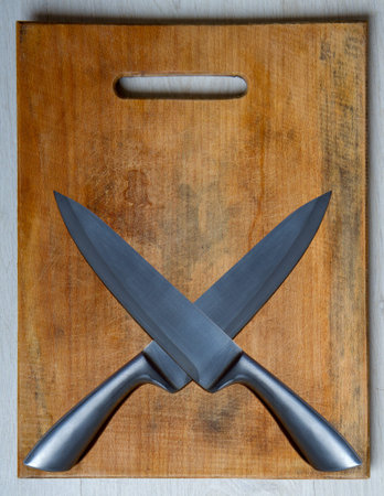 wood cutting board and sharp steel knife top view