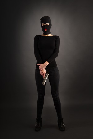Girl in Black with Gunの写真素材