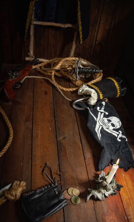 Items from pirated goods randomly laid out on the old ship's tableの写真素材