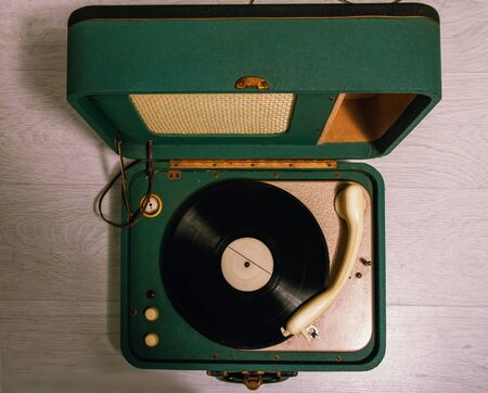 old green electric gramophone with music record top viewの写真素材