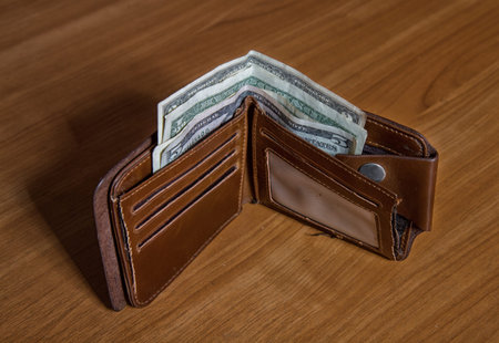 old leather wallet with small dollar bills