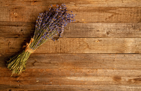 Bunch of dried lavender flowers on a rough wooden background