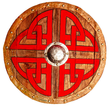 Viking round wooden brown shield decorated with a rough red-black pattern and metallic and copper protective elementsの写真素材