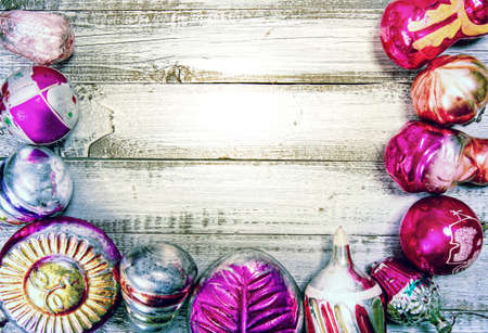 assorted glass vintage christmas tree decorations on rough wooden table with blank space for textの写真素材