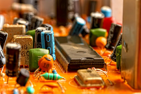 Old printed circuit board with resistors and capacitors from an analog TV close-up