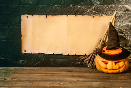 Blank manuscript with place for text witch's broom flying hat and pumpkin on dark backgroundの写真素材