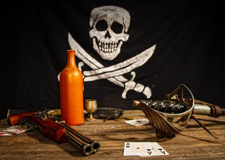 Pirate wooden table with weapons alcohol coins and playing cards