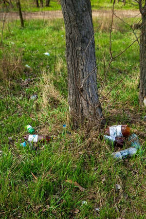 Nikolaev, Ukraine - 06 April 2021: Garbage in the park. Garbage, empty wrappers, packaging left by people after relaxing in the park in natureのeditorial素材