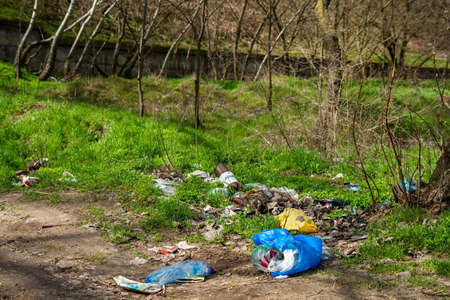 Nikolaev, Ukraine - 06 April 2021: Garbage in the park. Garbage, empty wrappers, packaging left by people after relaxing in the park in natureのeditorial素材
