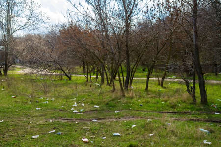 Nikolaev, Ukraine - 06 April 2021: Garbage in the park. Garbage, empty wrappers, packaging left by people after relaxing in the park in natureのeditorial素材