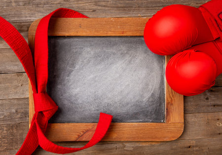 Empty space for your text with red gloves and a karate belt spread out next to it