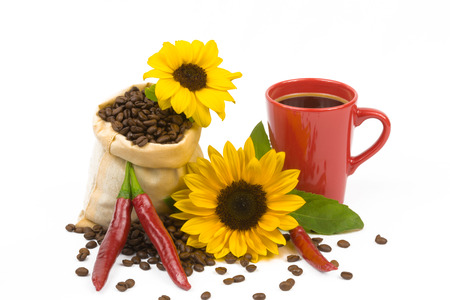 A bag of coffeebeans, chillis, a cup and sunflowersの写真素材