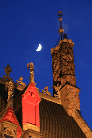 Roof and facade of the town house in Bruges at nightの写真素材